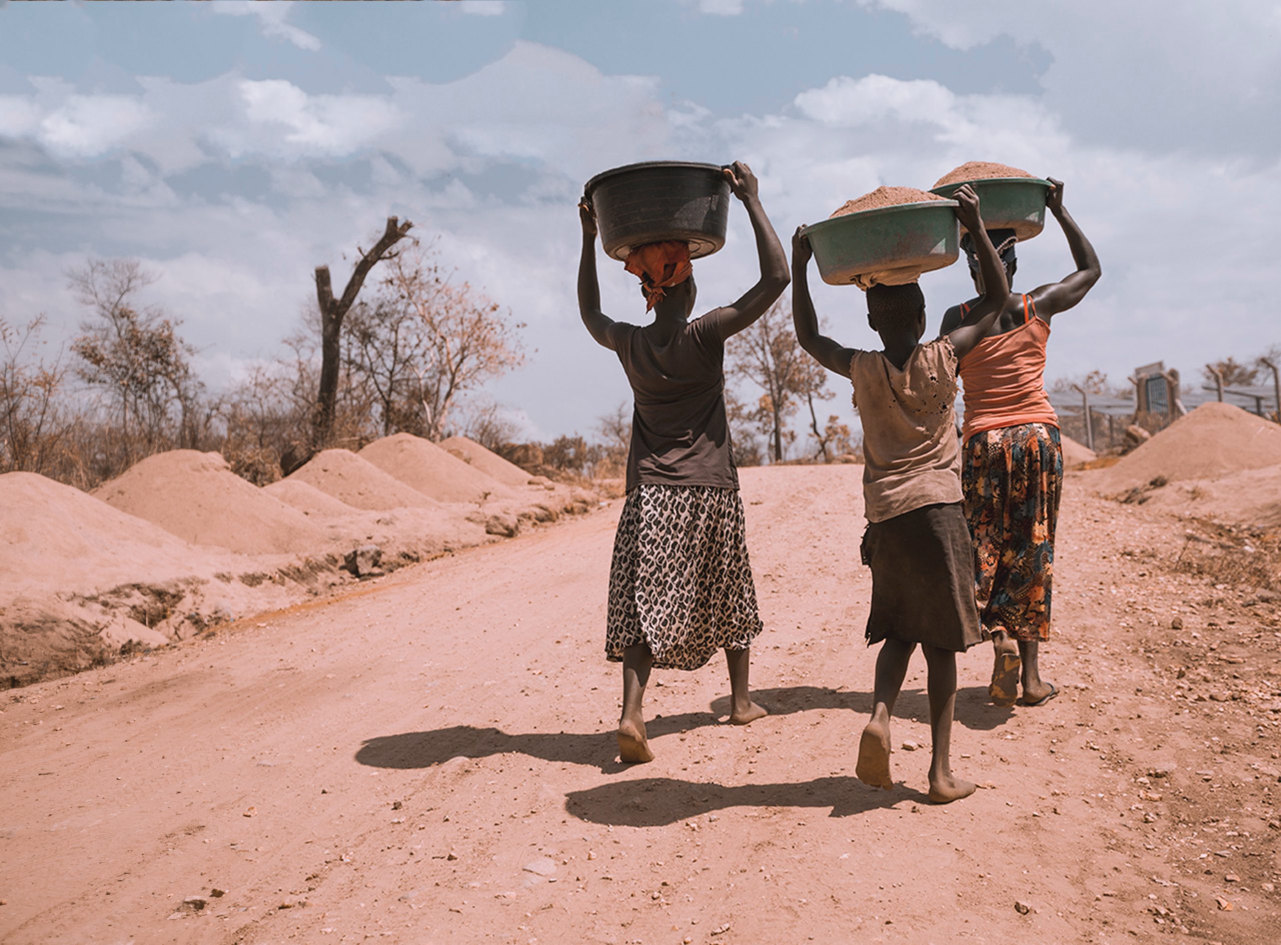 people carrying grain in Uganda
