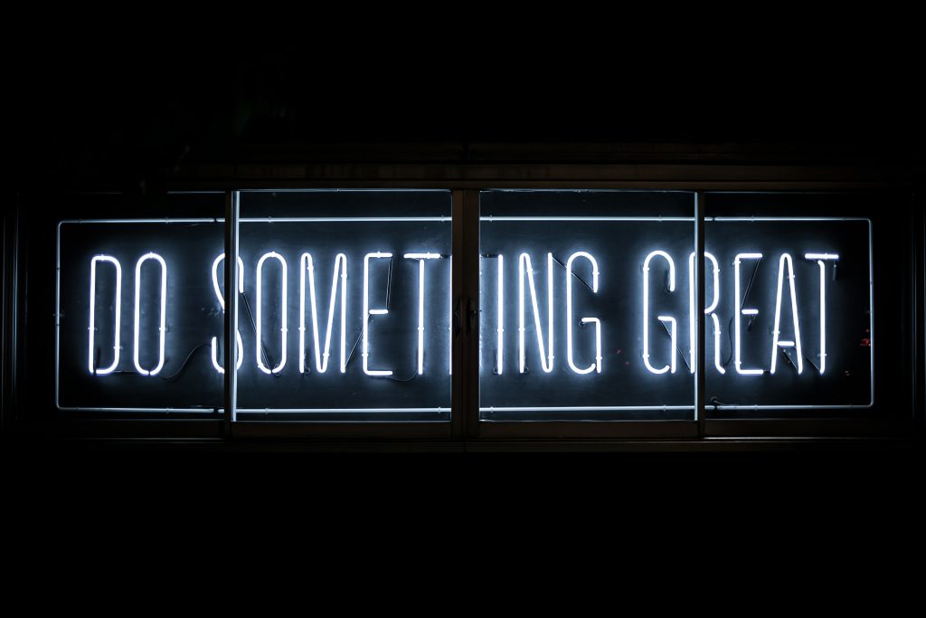 neon sign that reads "Do something great."