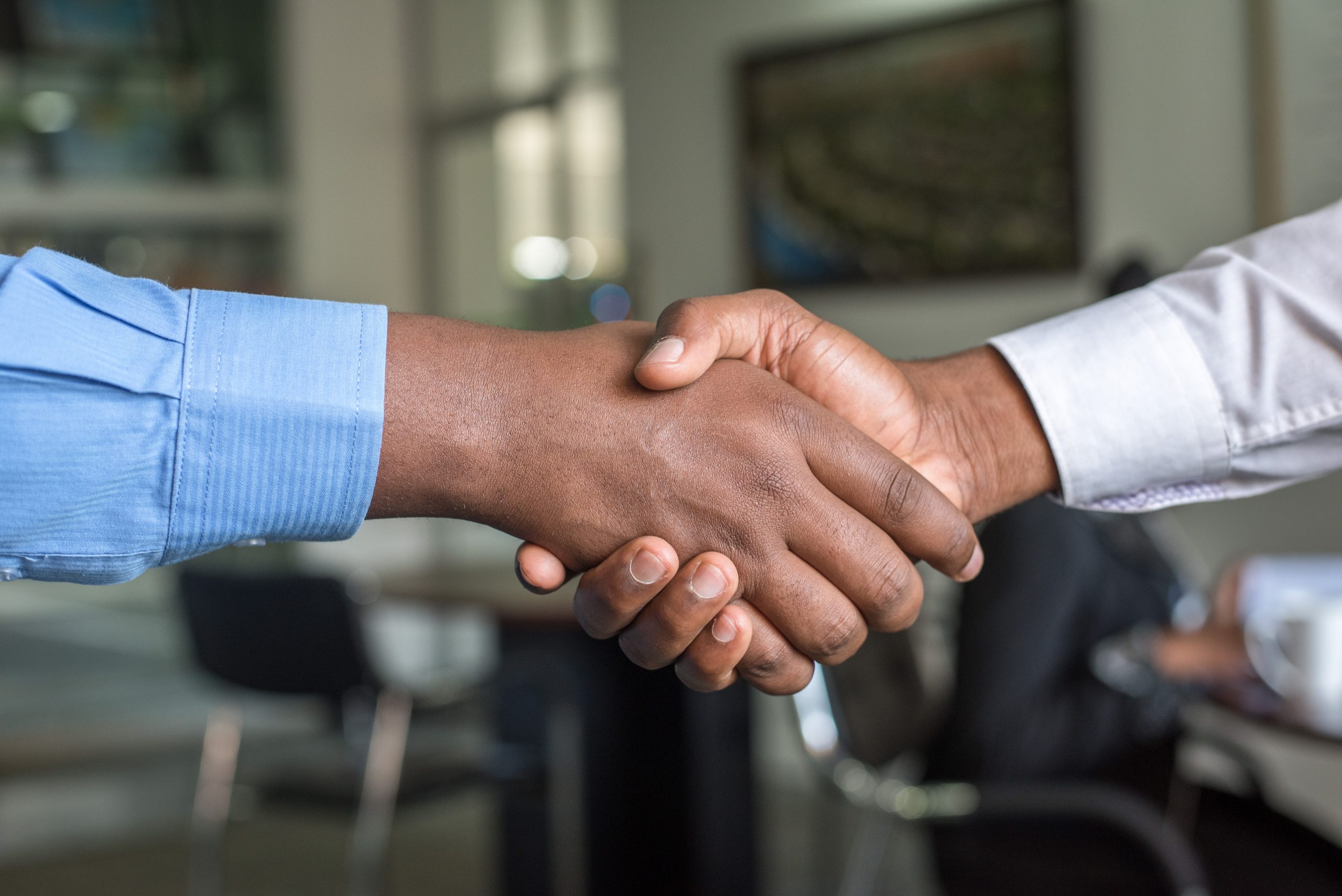 zoomed in photo of two black men shaking hands