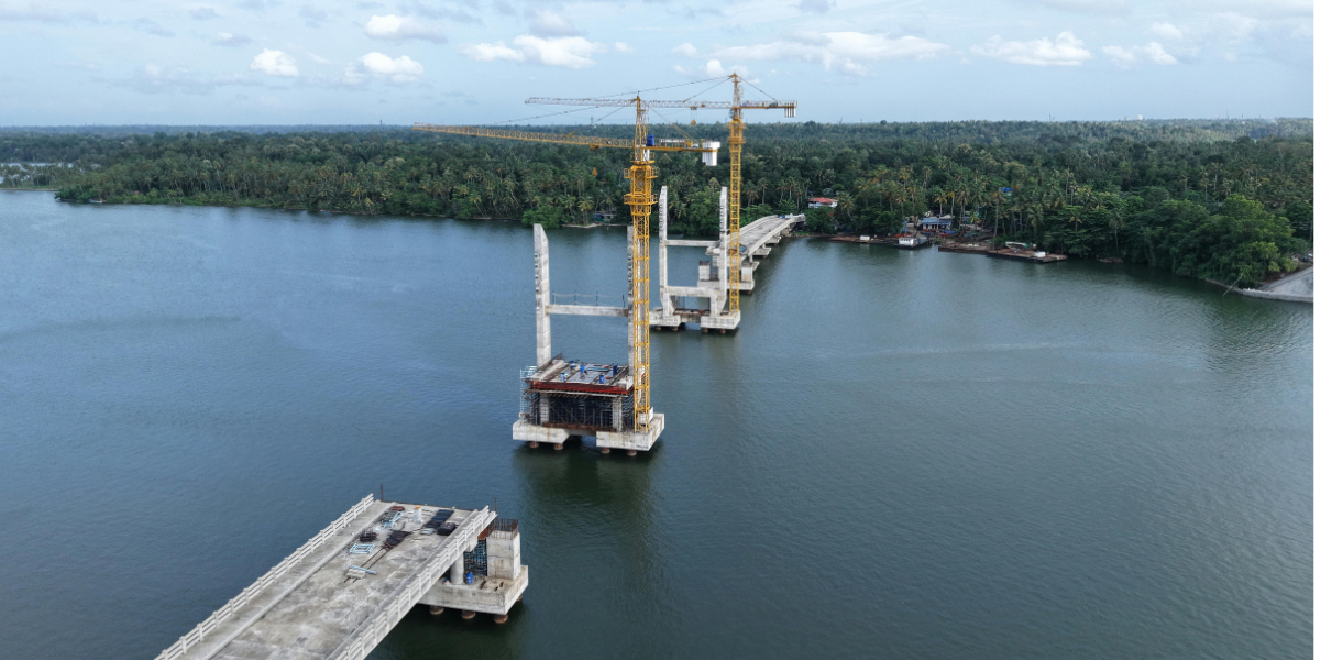 bridge construction over a river with a forest on one shore